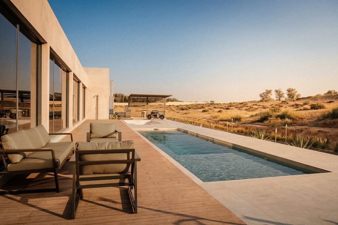 Loungers along the pool deck with the glass facade behind