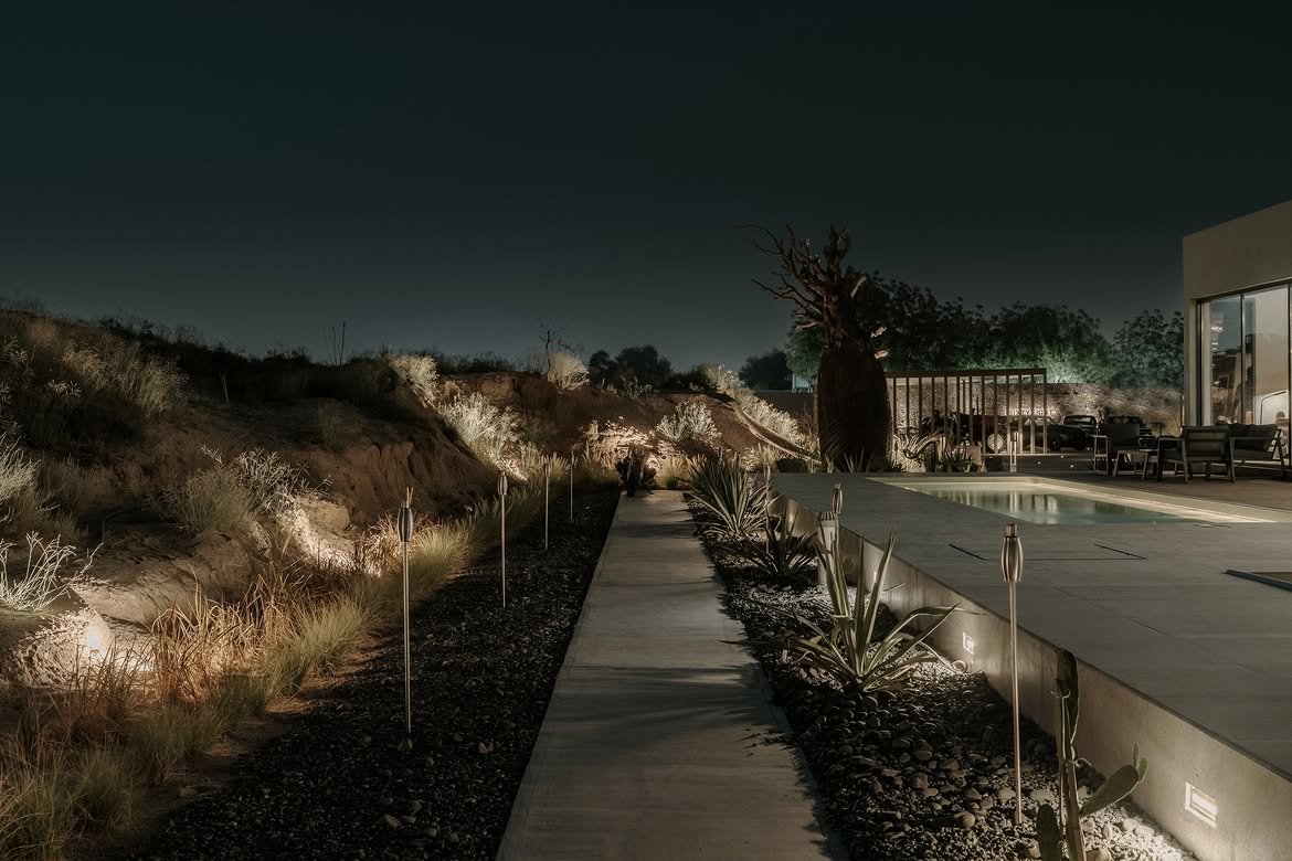 The lit path running alongside the pool into the dark